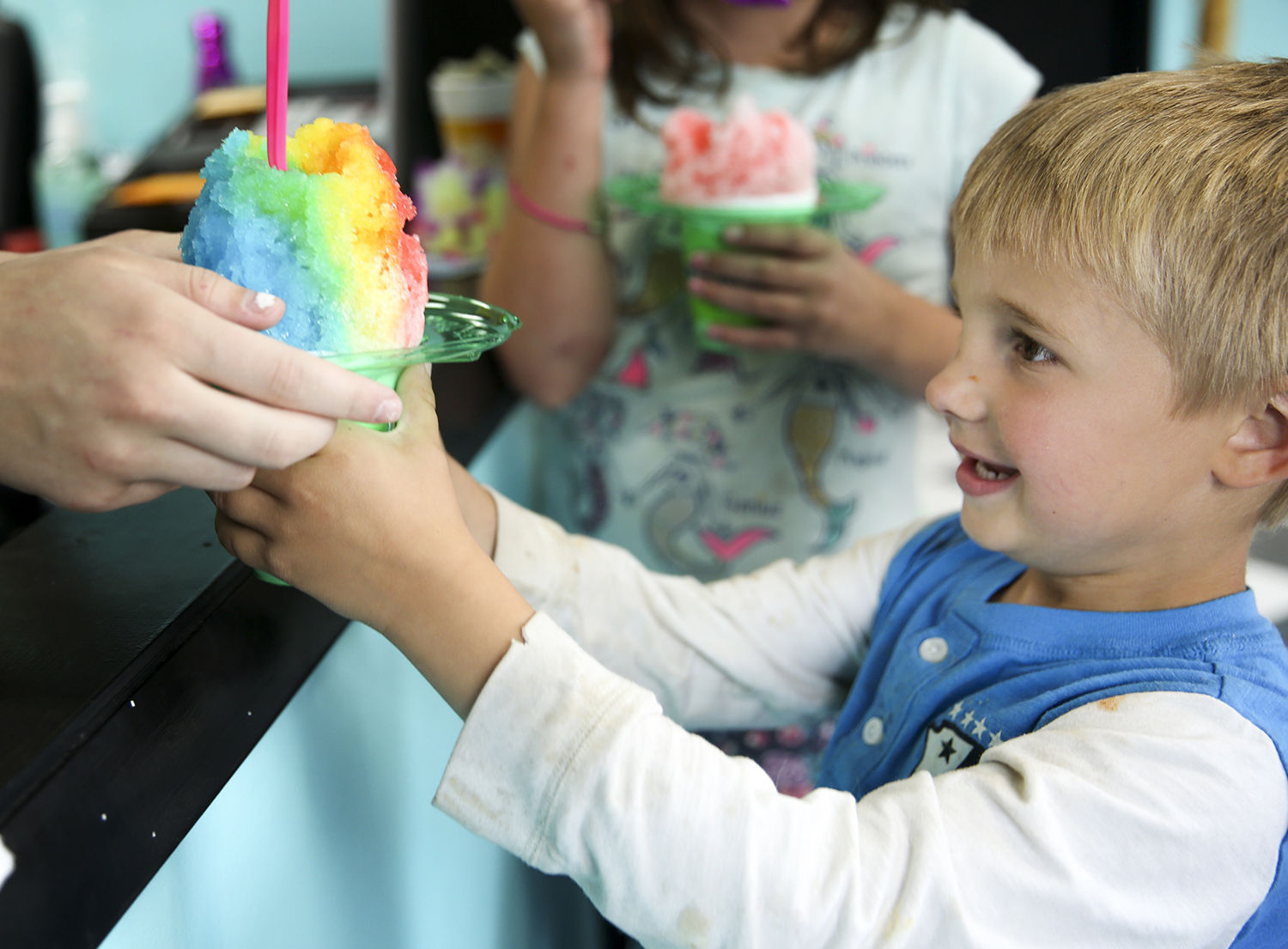 Dawson Golphenee, 6, grabs his rainbow snow cone